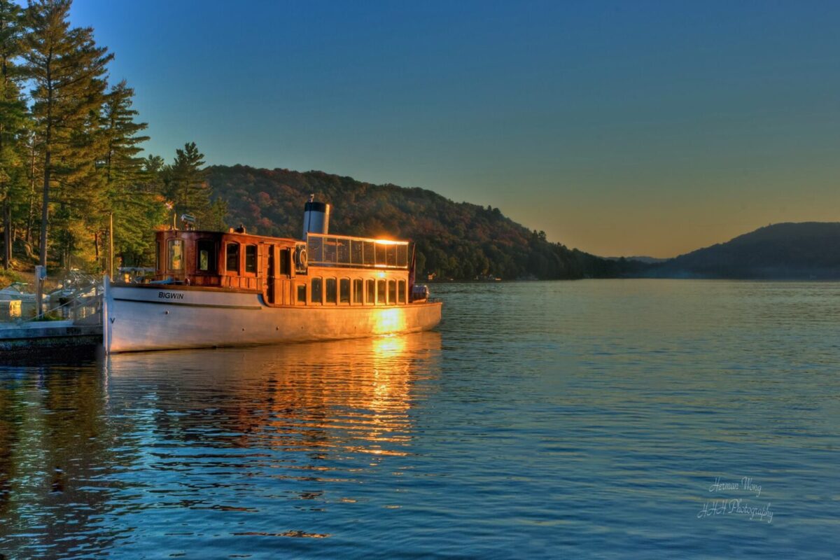 The S.S. Bigwin docked in front of a mountain landscape