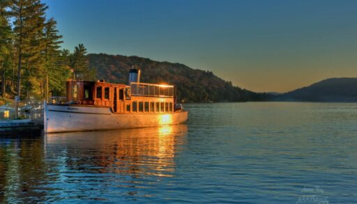 The S.S. Bigwin docked in front of a mountain landscape