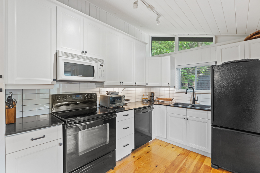 A bright kitchen with hardwood floors and updated appliances.
