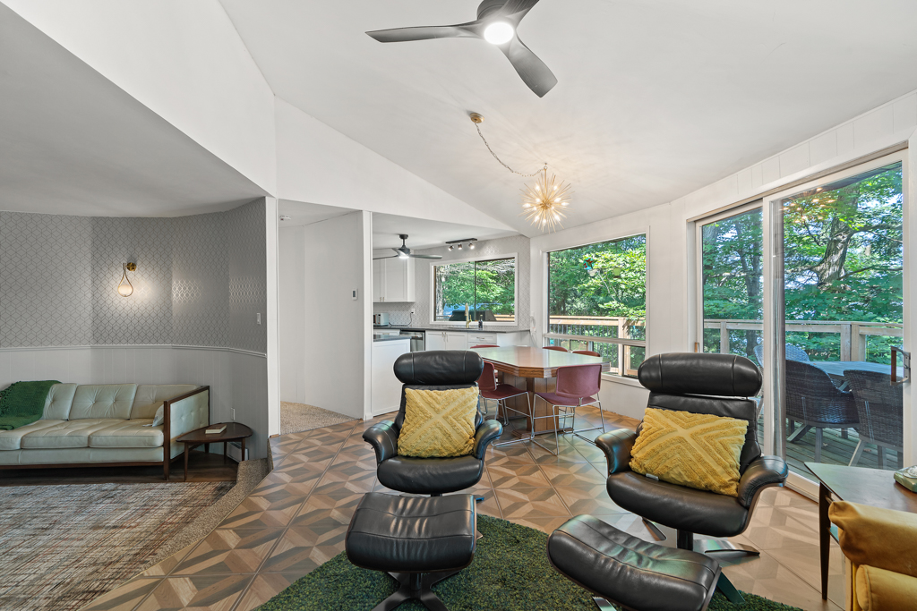 An open-concept layout with a dining area, a living area, and a den.