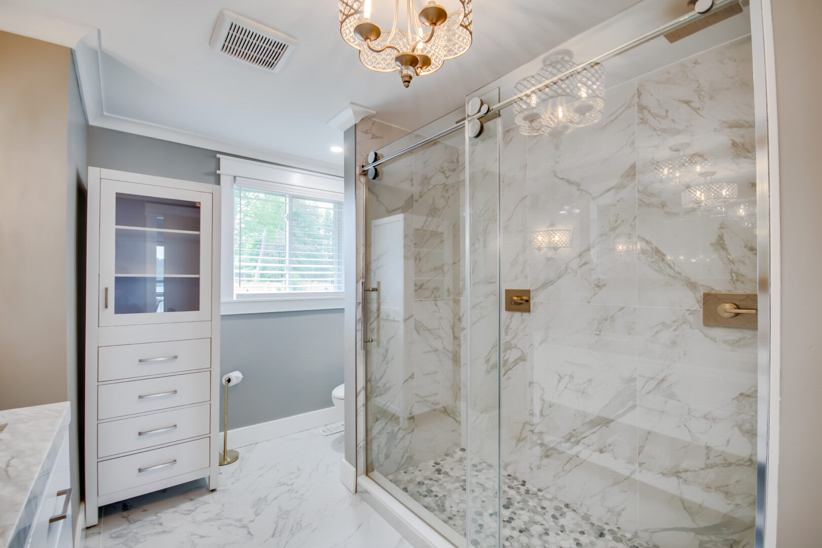 A large walk-in shower in a bright, modern bathroom.