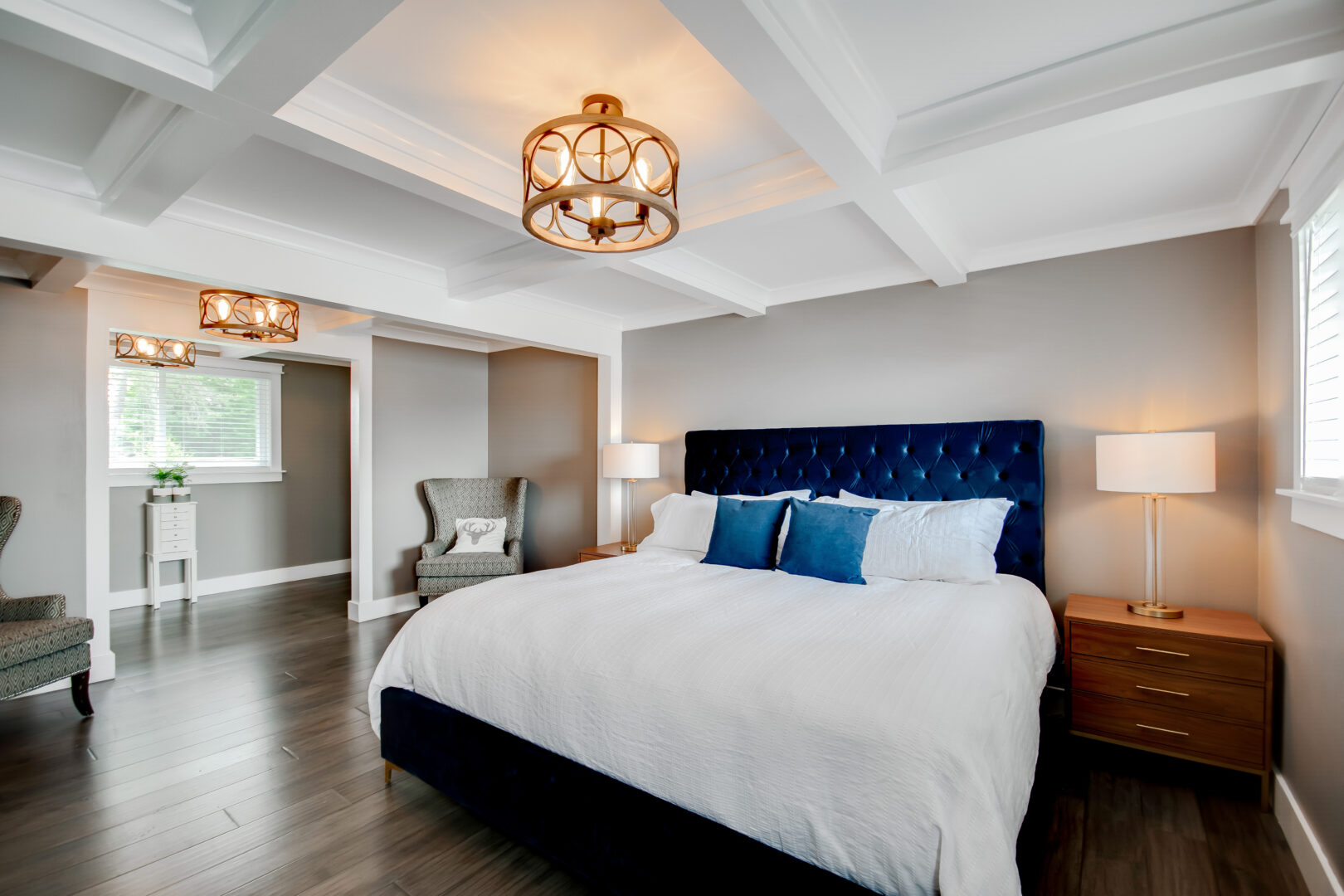 A big bedroom with a large bed, hardwood floors, and lots of natural light.