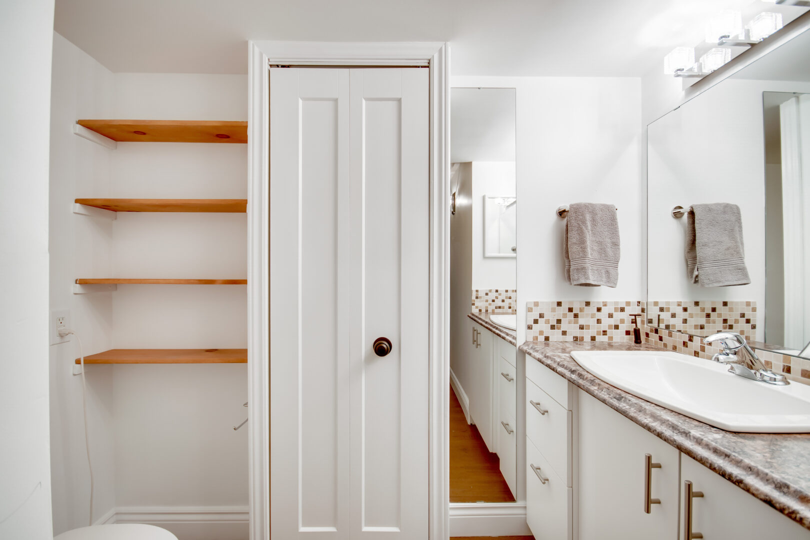 A small bathroom with lots of storage space.