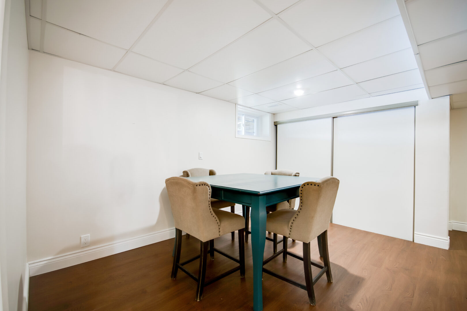 A small dining area with a table and chairs.