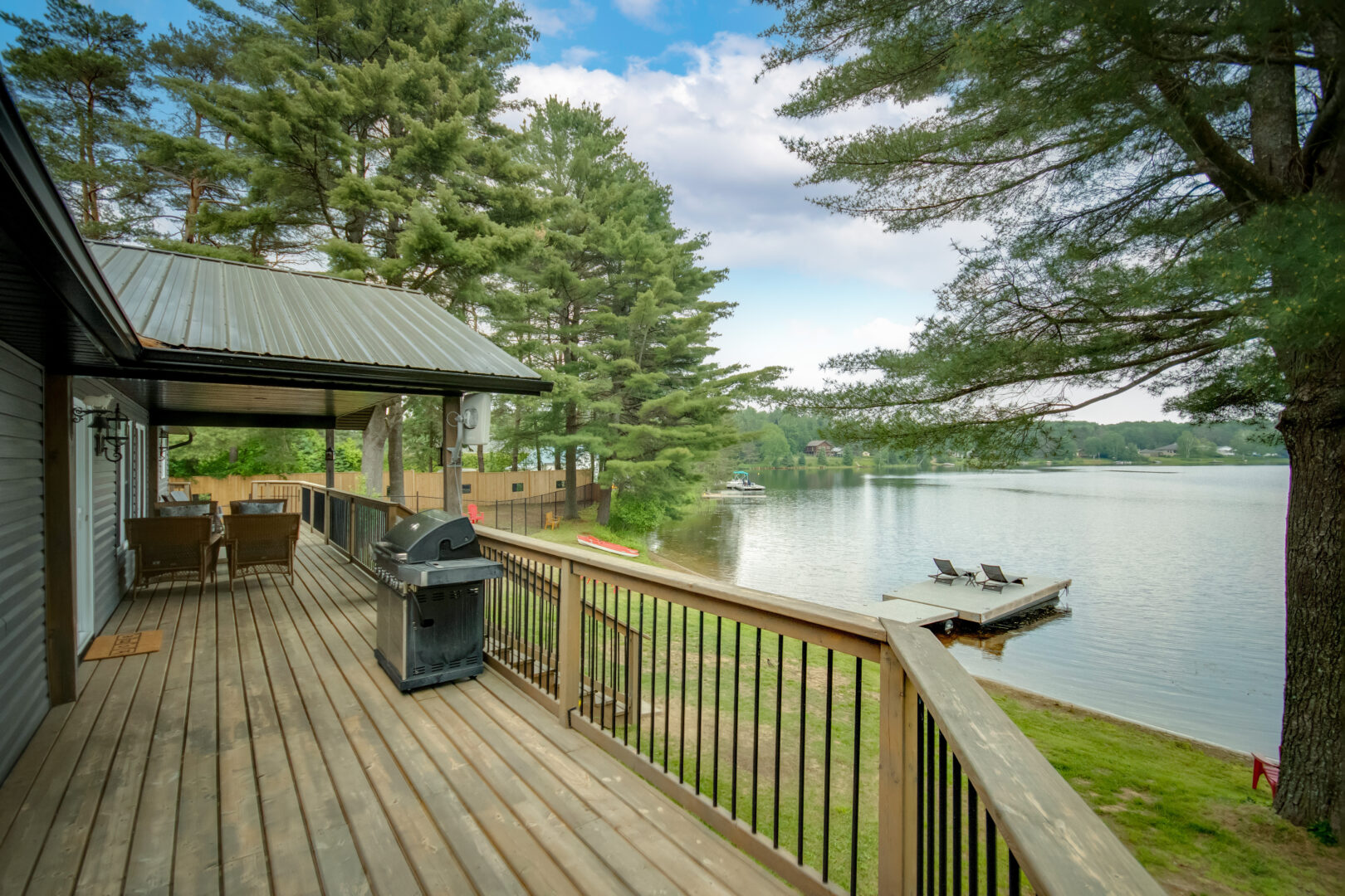 A wooden deck looks out over a lake.