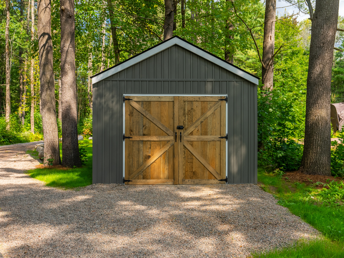 A new detached garage with wooden double doors.