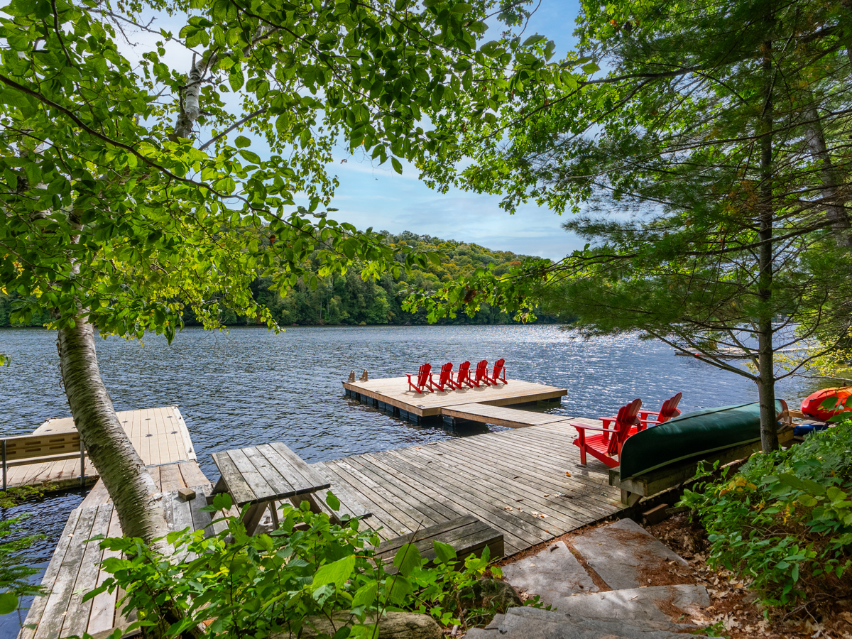 A large dock with two pieces on either side extending into a lake.