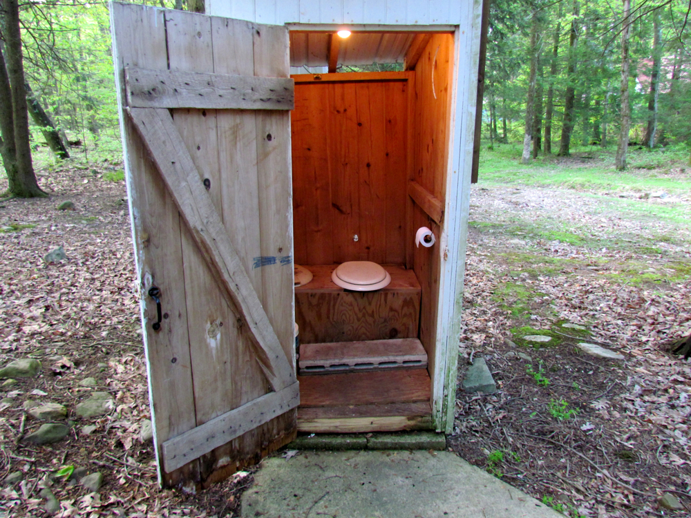 Outhouse door open with lights on inside