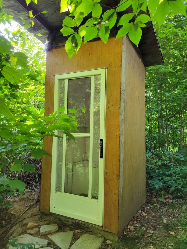 Outhouse with a glass screen door