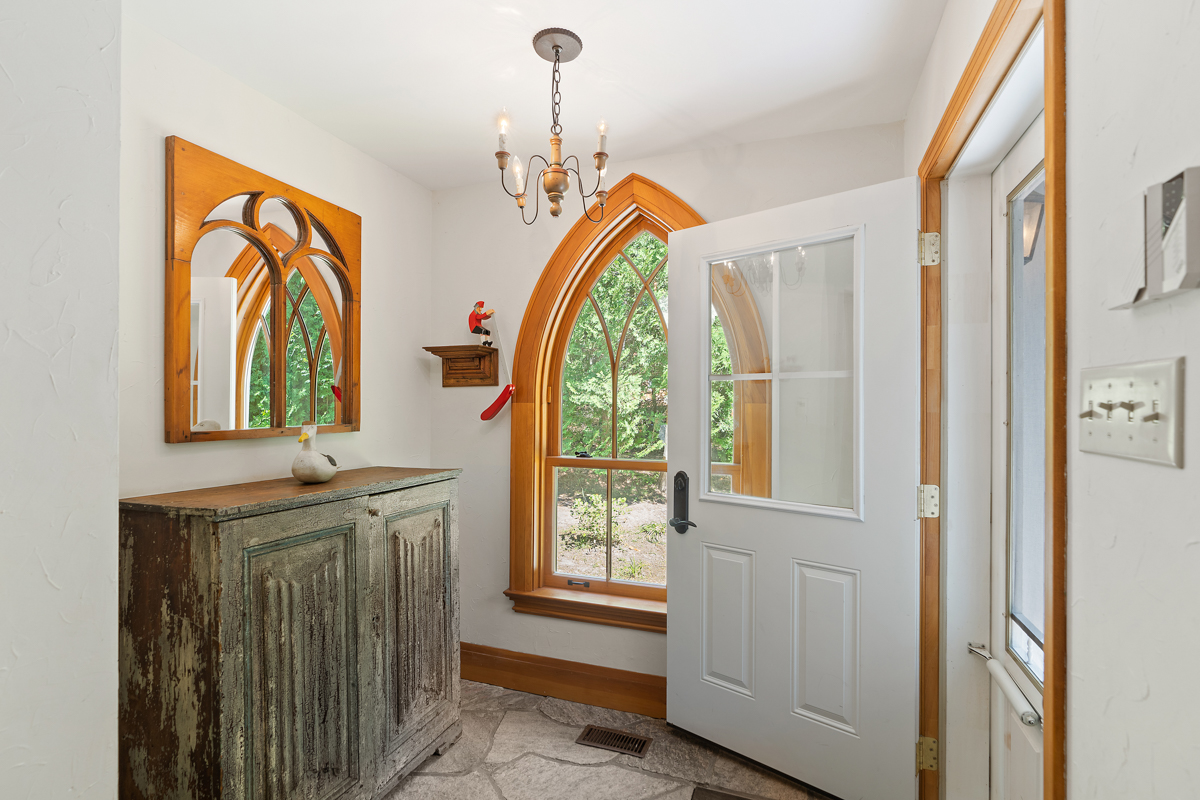 A bright front entrance area inside a large cottage.