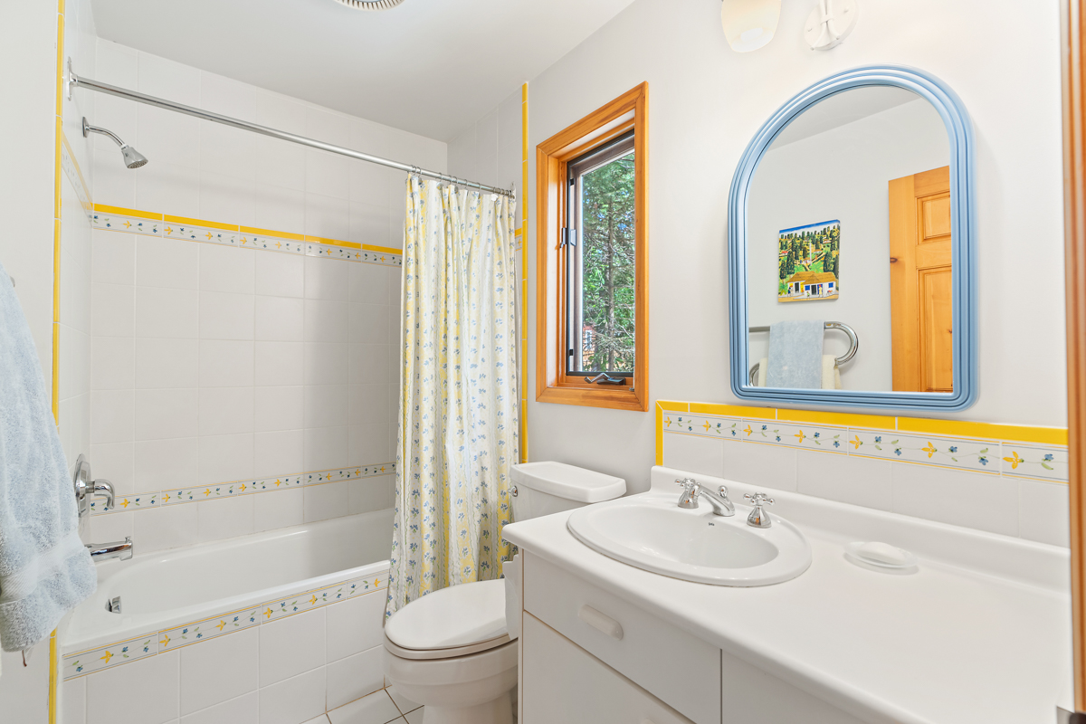 A bathroom with a toilet, a sink, and a shower-tub combo.