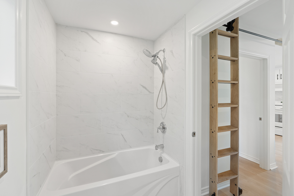 A bright bathroom with a shower-tub combo.