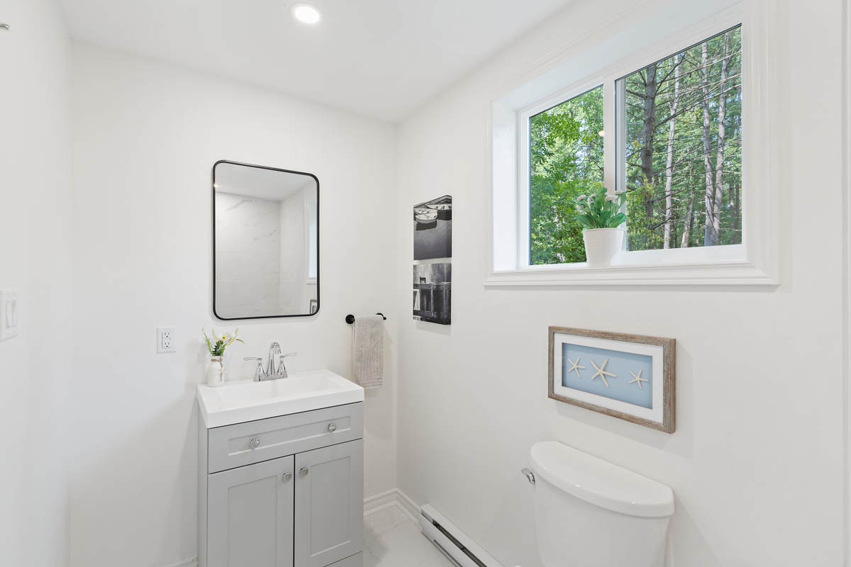 A bright bathroom with a toilet and a sink.