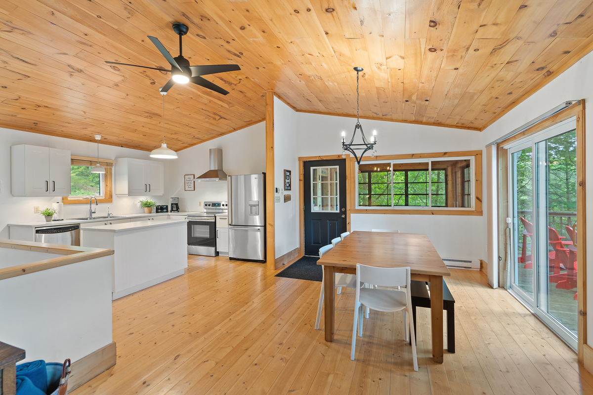 A main floor open-concept kitchen and dining area with modern appliances and a table and chairs.