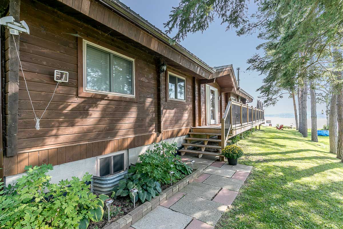 A walkway leads to the front door of a bungalow.
