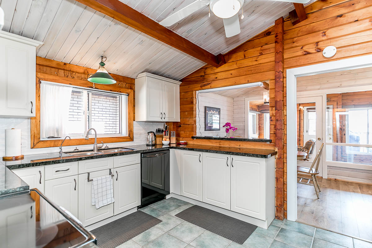 A small kitchen with white cupboards and a dishwasher.