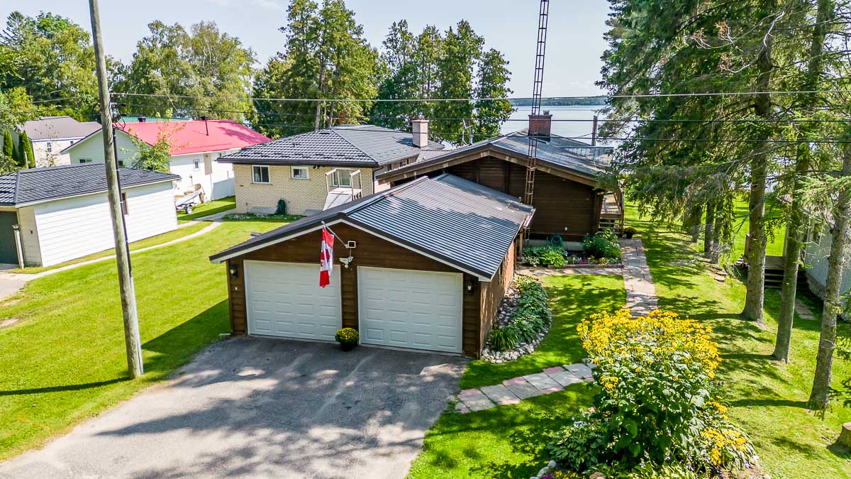 Overhead view of a cottage bungalow with a two-car garage.