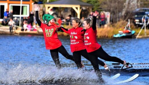 Three people slalom ski