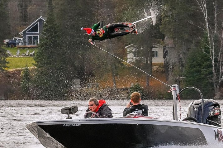 A person on a hydrofoil midair during a flip