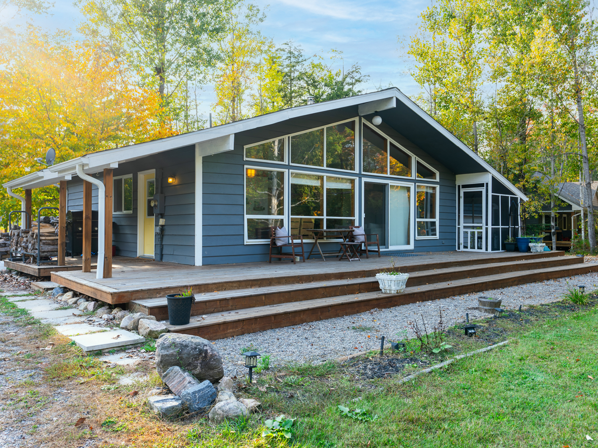 Front of cottage. Floor-to-ceiling windows span the front of the bungalow.