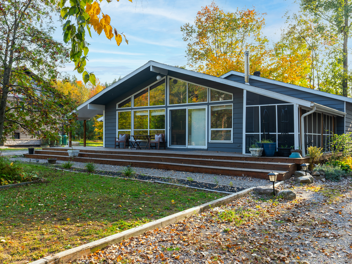 Front of cottage. Floor-to-ceiling windows span the front of the bungalow.