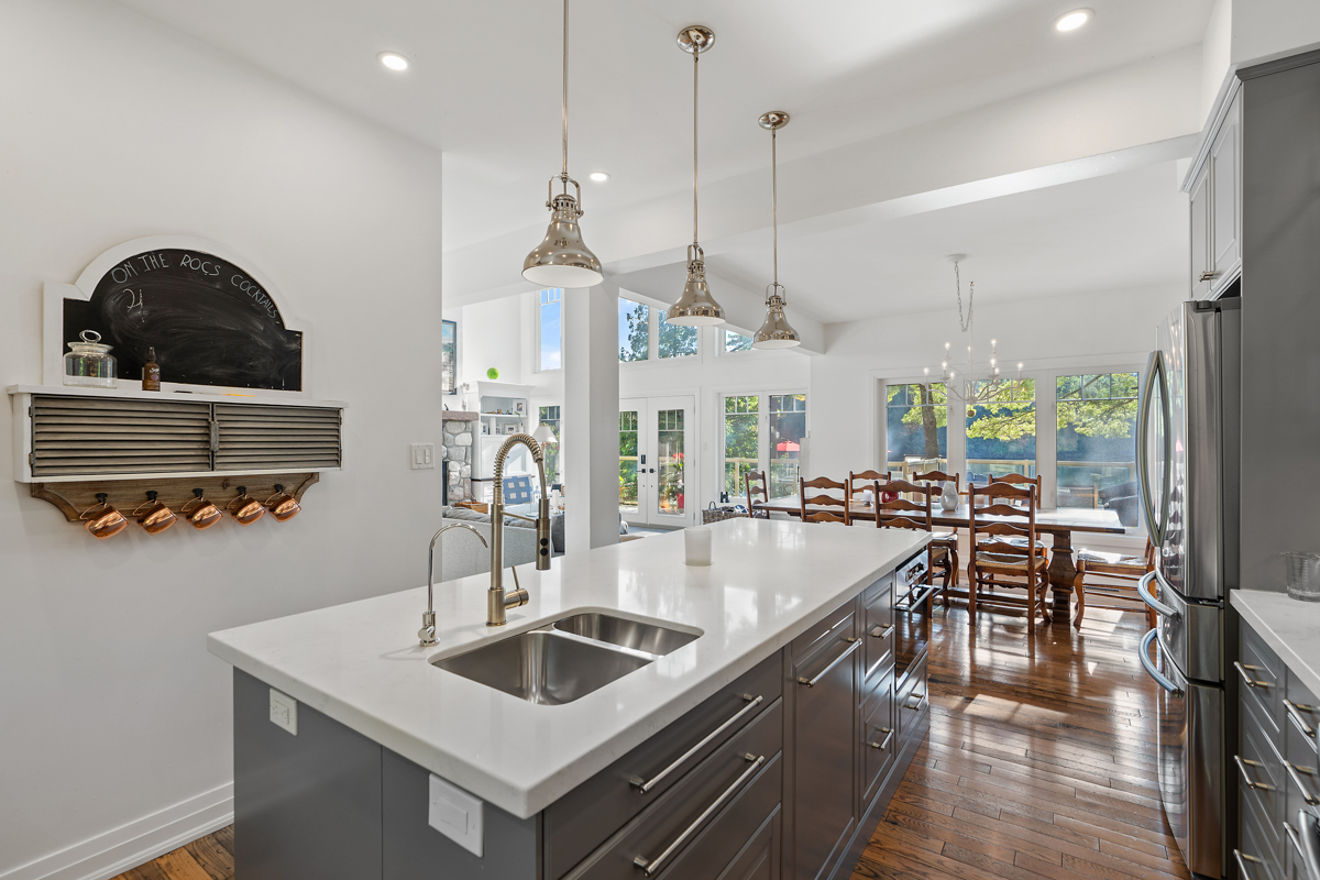 A big, modern kitchen with an island, modern appliances, and light grey cabinets.