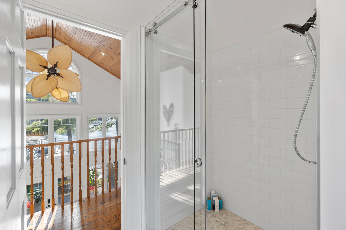 A big bathroom with a walk-in shower off an upstairs hallway.