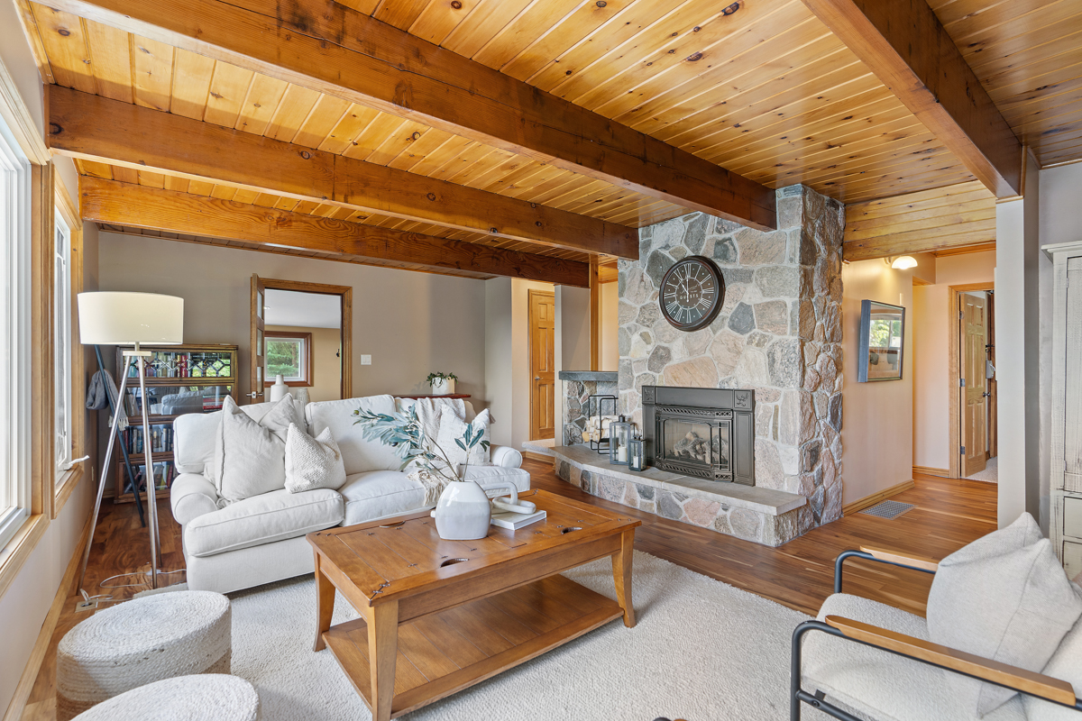 A bright living area with white furniture.