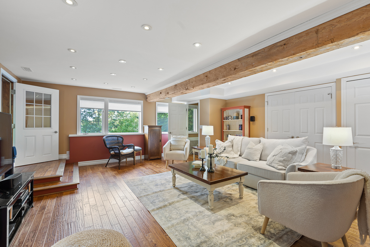 A bright living area with a couch and chairs.