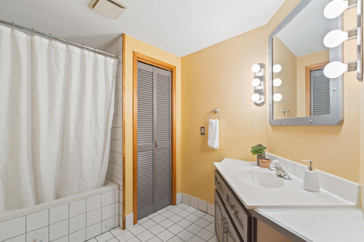 A bathroom with a shower and a sink.
