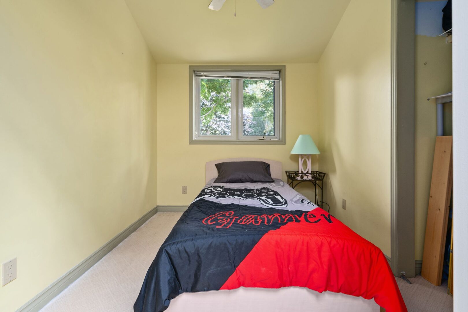 A small, narrow bedroom with a single bed.