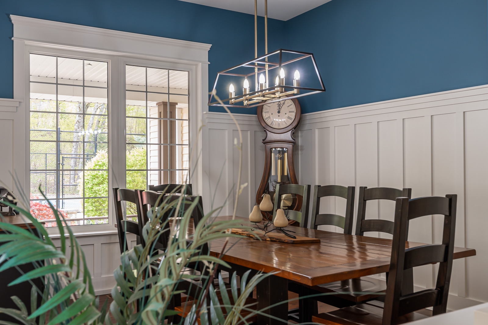 A bright dining area with a table and chairs and a big window.