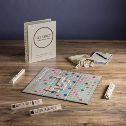 Scrabble board, tiles and box on a table
