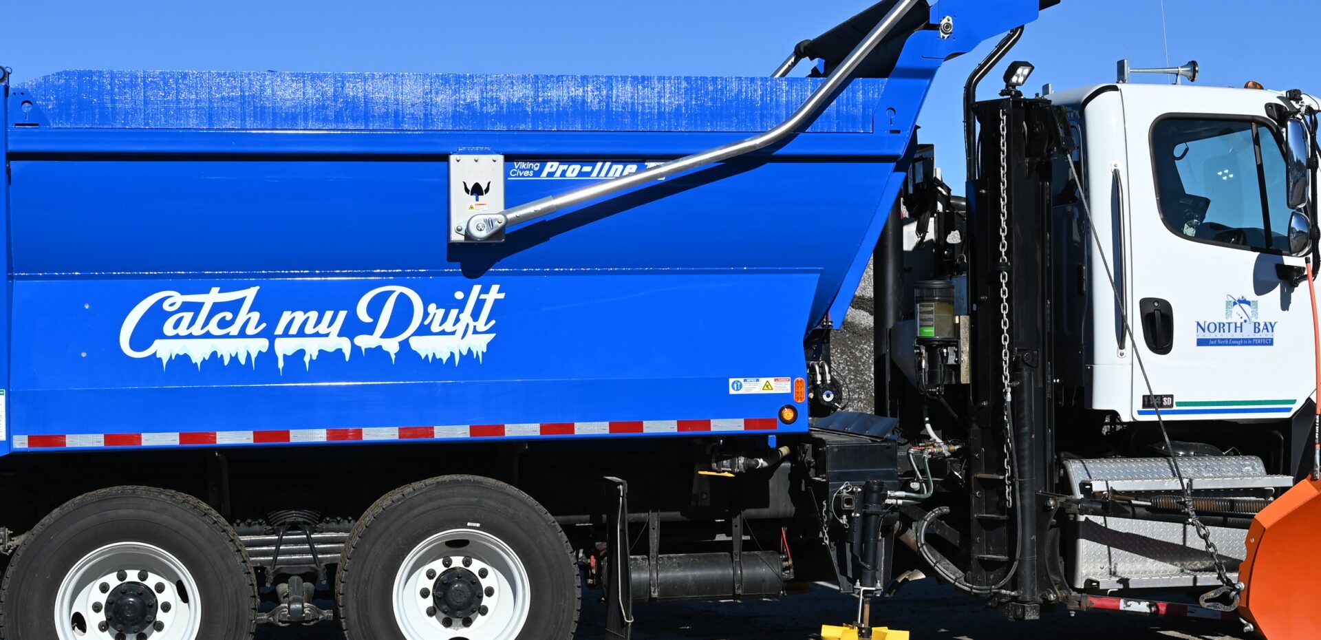 snowplow with "Catch My Drift" graphic on it