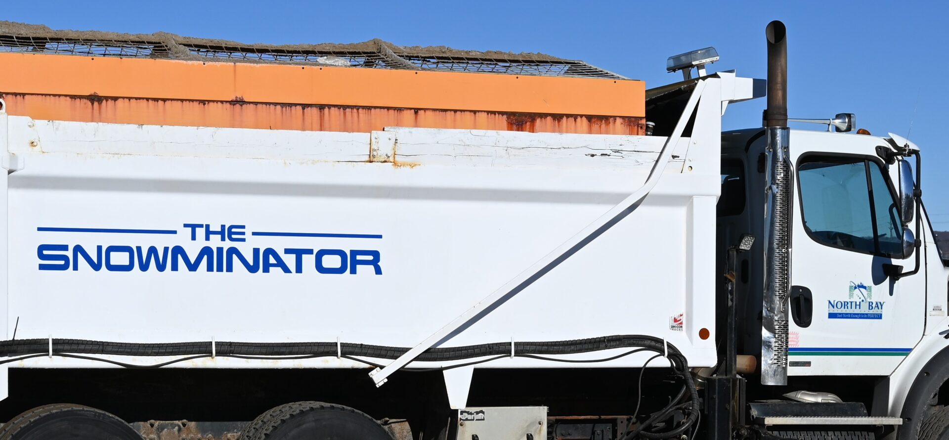 snowing a white snowplow named "The Snowminator"