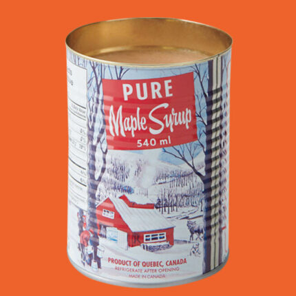 Metal can with a snowy red cabin and trees on the outside and candle wax on the inside