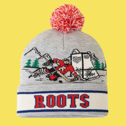 hat with hockey player infront of a net, with a red pompom on top