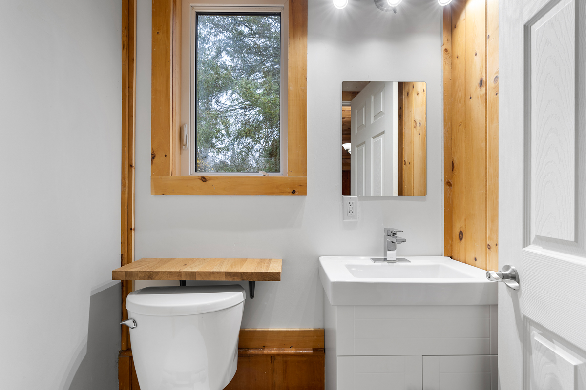 A small powder room with a toilet and a sink.