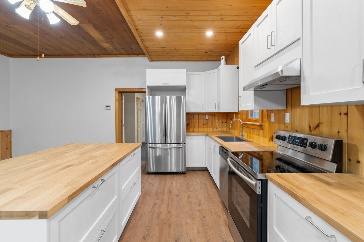 A bright kitchen with a large island and updated appliances.