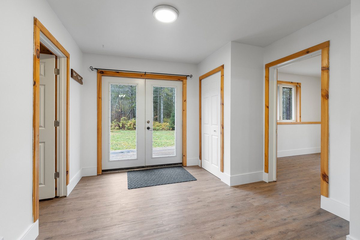 A wide side entrance area with double-doors to outside.