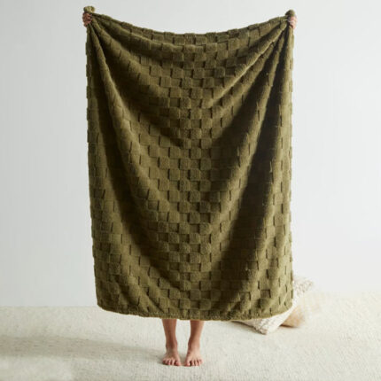 a person holding a green blanket