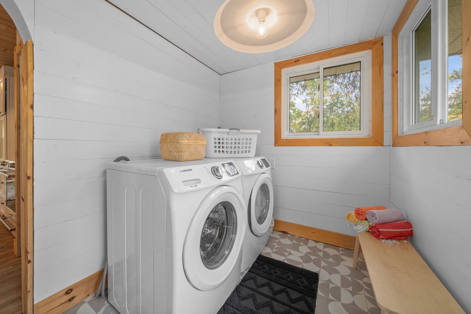 A small but bright area with a washing machine and a dryer.