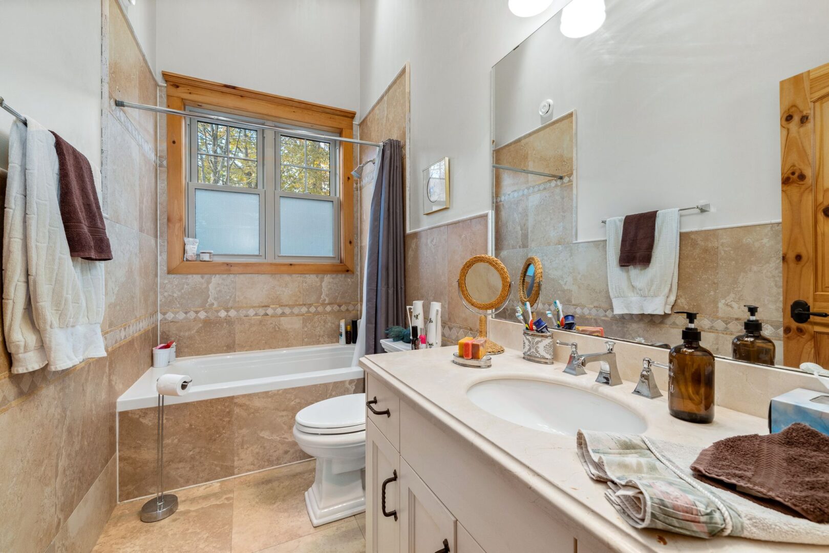 A three-piece bathroom with a sink, a toilet, and a shower-tub combo.