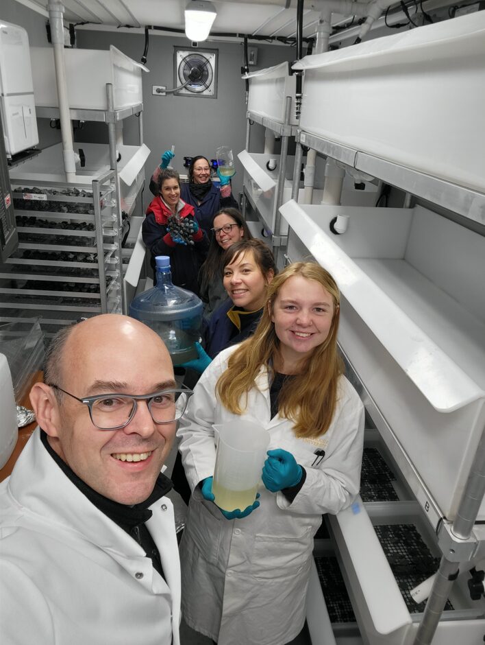 A photo of the sugar kelp research team inside the shipping container.