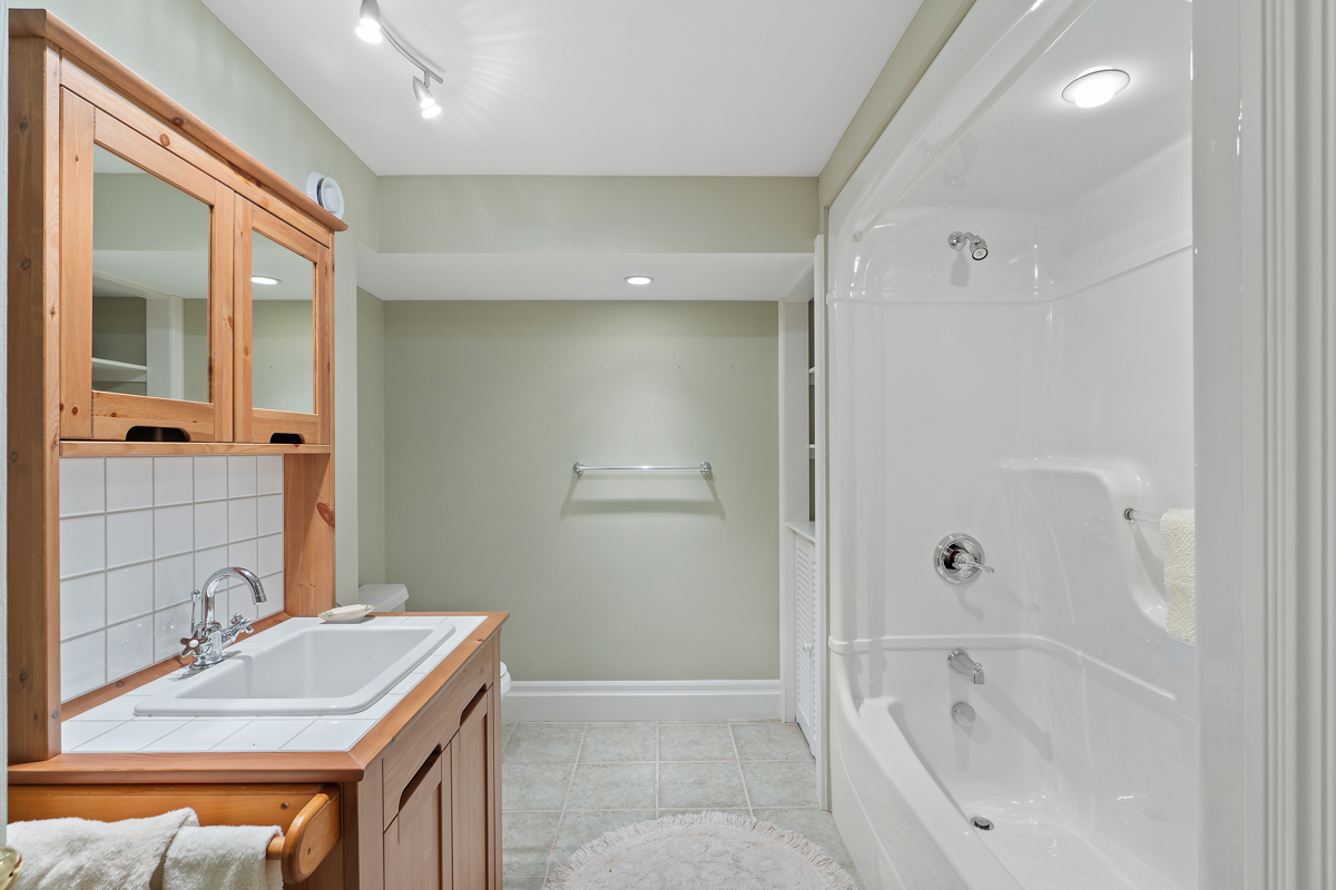 A big bathroom with a toilet, a sink, and a shower-tub combo.