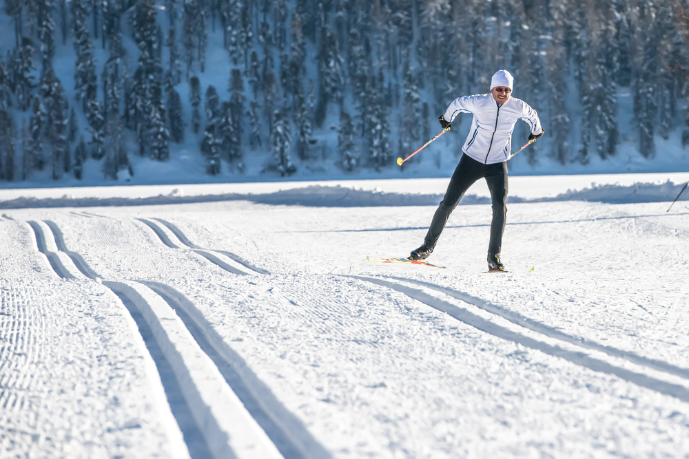 A man practicing skate skiing on flat, snowy ground