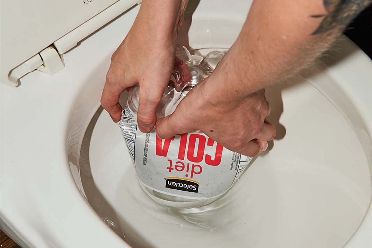 Someone using a pop bottle as a plunger