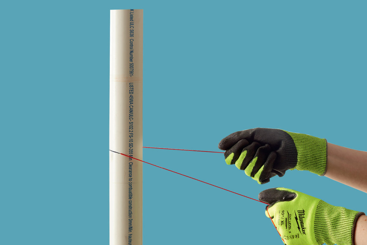 Someone cutting PVC pipe with a string