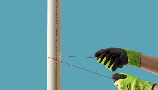 A person cutting PVC pipe with a string.