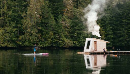 a photo of an outdoor sauna in on the dock in the middle of the lake